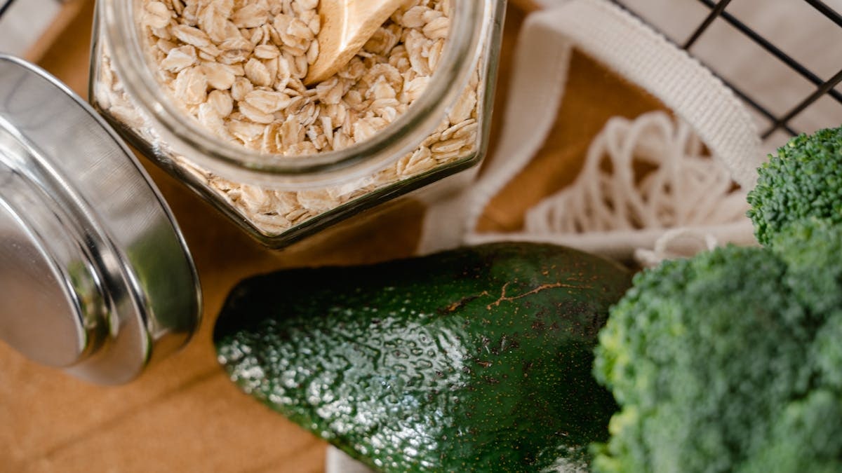 A close-up of oats, avocado, and broccoli in eco-friendly packaging, promoting a no plastic lifestyle.